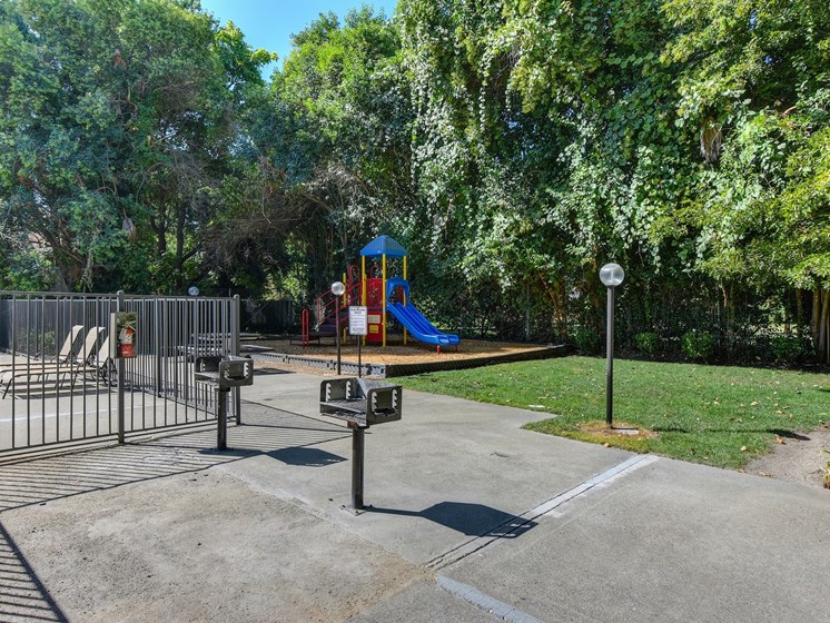 BBQ Area with Playground, Jungle Gym, Grass, Gates and Street Light